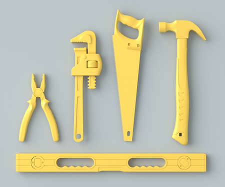 Top view of monochrome construction tools for repair on grey and yellow