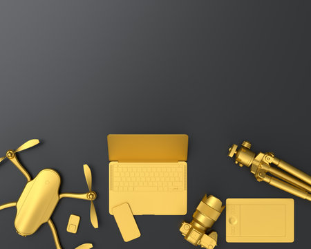 Top view of gold designer workspace and gear like laptop, tablet, drone, lens pen and mobile phone on black table background. 3d rendering of accessories for drawing, sketching and photography toolsの写真素材