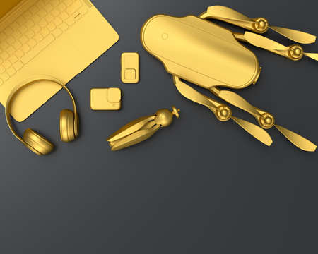 Top view of gold designer workspace and gear like laptop, headphones, drone, tripod and action...