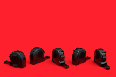 Set of black carpenter measuring tape on red background with units scale