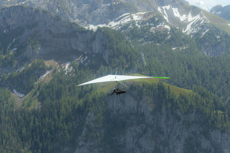 Hang gliding above mountain valley near Jenner mount and Konigssee lake in Berchtesgaden National...