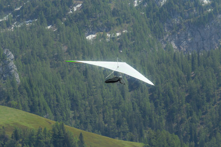 Hang gliding above mountain valley near Jenner mount and Konigssee lake in Berchtesgaden National...