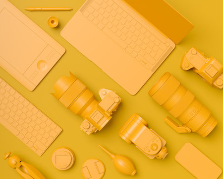 Top view of gold designer workspace and gear like laptop, tablet, digital camera and spidlight flash on monochrome background. 3d rendering of accessories for illustrator and photography toolsの写真素材