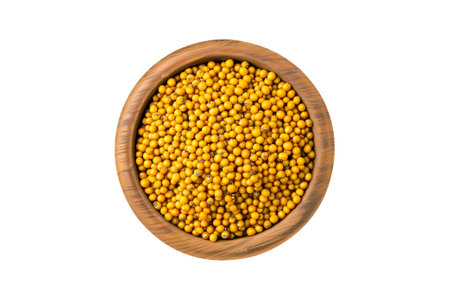 Yellow mustard seeds in a wooden scoop isolated on white transparent backgroundの素材