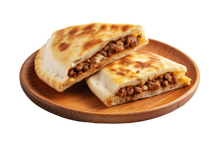 Grilled stuffed flatbread like Arayes pita filled with seasoned minced meat on wooden plate, isolated on white transparent background, concept of traditional Arabic street foodの素材