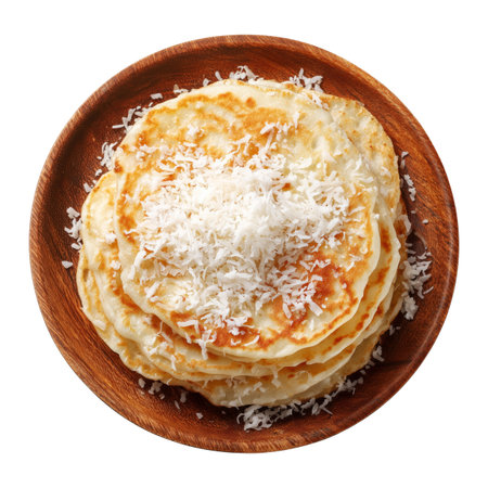 Coconut pancakes stacked with coconut flakes and syrup on wooden plate, isolated on white transparent background, concept of breakfast, Fijian Takeaway and Street Foodsの素材