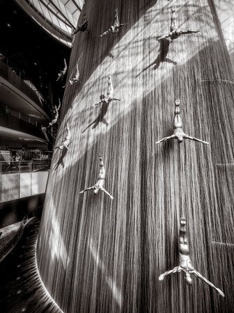 Famous Waterfall with art fiberglass sculptures of human divers in Dubai Mall, UAE.の写真素材