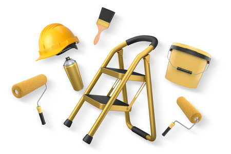 Assorted painting tools including rollers, brush, spray can, helmet, and step ladder isolated on white background with clipping path, representing home renovation conceptの写真素材