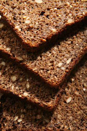  Slices of rye-bread on wood surface.