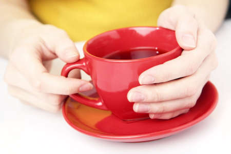 Red cup in female hands.の写真素材