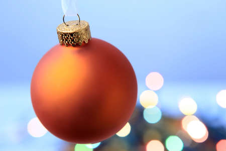 Christmas golden ball with color light blur in the backgroundの写真素材