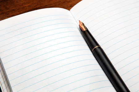 Fountain pen on an opened notepad