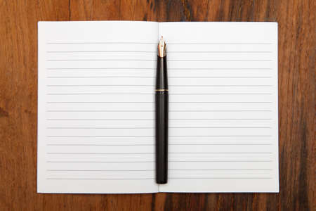 Fountain pen on an opened notepadの写真素材