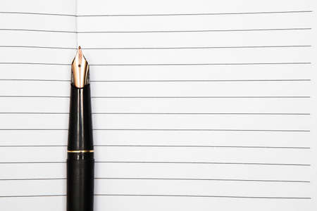 Fountain pen on an opened notepadの写真素材