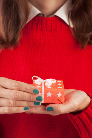 Close-up of female hands unpacking a present