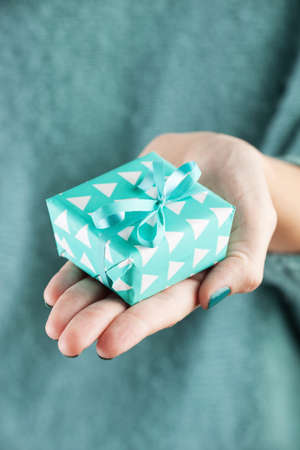 Close-up of female hand holding a presentの写真素材