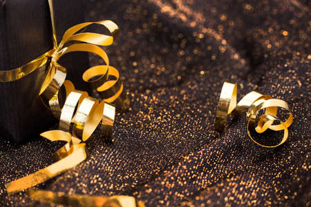 Black gift box on black shiny background.の写真素材