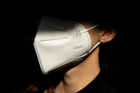 Young woman wearing KN-95 protection medical mask. Prevention of the spread of virus and epidemic,...
