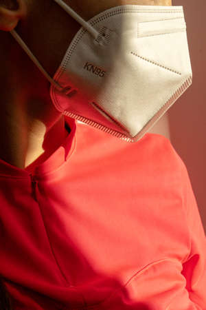 Young woman wearing KN-95 protection medical mask. Prevention of the spread of virus and epidemic, protective mouth filter mask. Diseases, air pollution and coronavirus defense concept.の写真素材