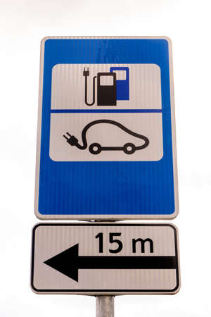 Electric car charging point sign in nature. EV parking and recharging road sign.