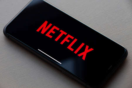Netflix logo on Apple iPhone 11. Netflix is a global provider of streaming movies and TV series.のeditorial素材
