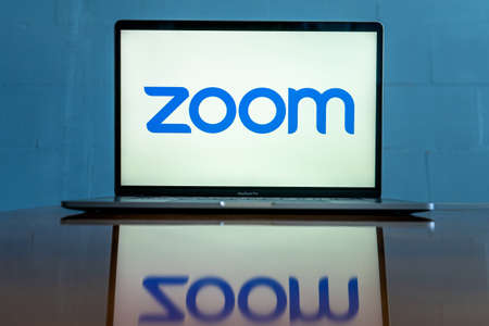 Laptop showing Zoom Cloud Meetings app logo. Work and have meetings from home.