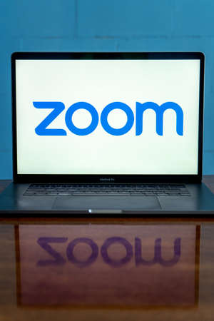 Laptop showing Zoom Cloud Meetings app logo. Work and have meetings from home.のeditorial素材