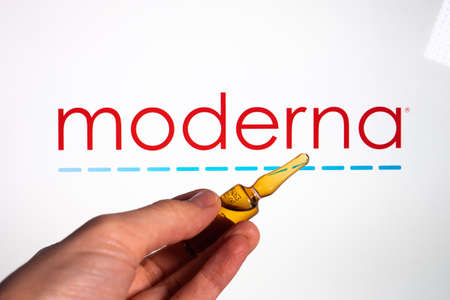 Moderna coronavirus vaccine pharmaceutical corporation. Moderna logo with hand holding vaccine.