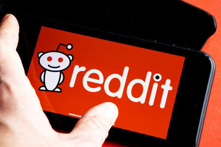 Reddit is a social news aggregation, web content, and discussion website. Registered members submit content to the site. Reddit logo on iPhone 11のeditorial素材