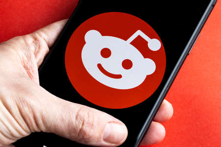 Reddit is a social news aggregation, web content, and discussion website. Registered members submit content to the site. Reddit logo on iPhone 11のeditorial素材