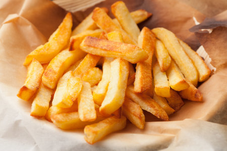 Homemade Golden French Fries in a Baking Paper Ready to Eat