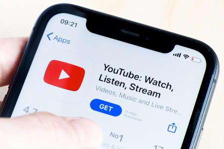 YouTube application icon on Apple iPhone X screen close-up. YouTube is a video-sharing social...