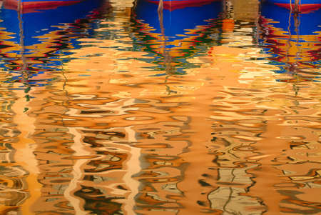 Reflection of Luzzu boats in water. Marsalforn, Gozo, Malta, Europe.の写真素材