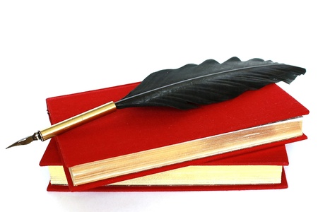 Two red books and quill isolated on white backgroundの写真素材