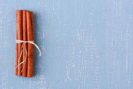 Cinnamon on Blue Wood with Pineconesの写真素材