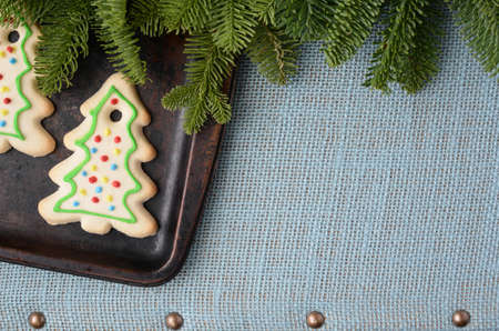 Holiday Cookies on Light Blue Textured Background with Part of A Tree