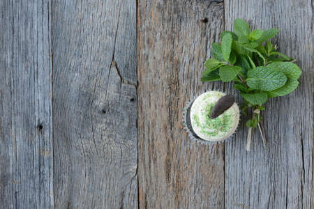 Mint Cupcake With Fresh Mint Leaves on Wooden Backgroundの写真素材