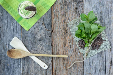 Mint Cupcake With Fresh Mint Leaves on Wooden Backgroundの写真素材