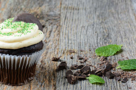 Mint Cupcake With Fresh Mint Leaves on Wooden Backgroundの写真素材