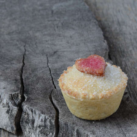 Black Berry Pie Cupcake with Heart and Sugar Topping on Wooden Backgroundの写真素材