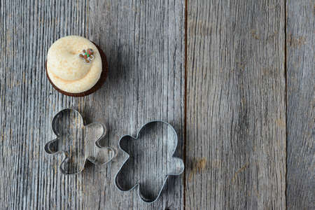 Holiday Cupcake with Gingerbread Man  Cookie Cutters on Wooden Backgroundの写真素材