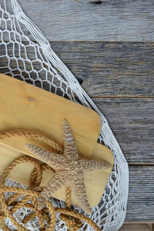 Sail Oars with Fish Net, rope and Starfish on Wood Backgrondの写真素材