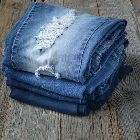 Denim Jeans on Wooden Backgroundの写真素材