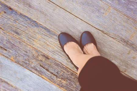 Feet. First-Person view  on rustic wood Floor background.の写真素材