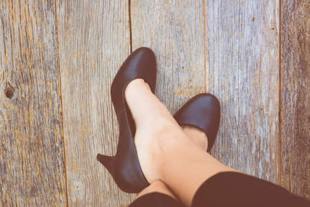 Feet. First-Person view  on rustic wood Floor background.の写真素材