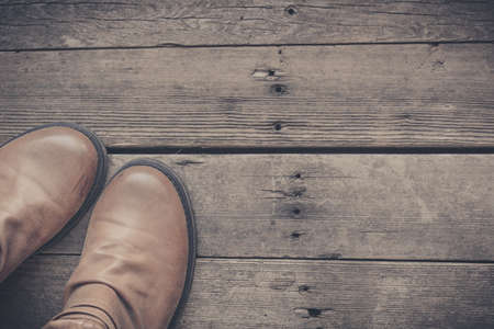 Feet. First-Person view  on rustic wood Floor background.