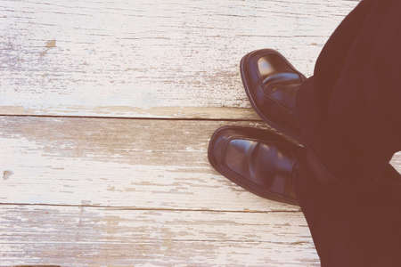 Feet. First-Person view  on rustic wood Floor background.