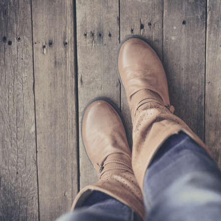 Feet. First-Person view  on rustic wood Floor background.