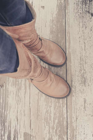 Feet. First-Person view  on rustic wood Floor background.