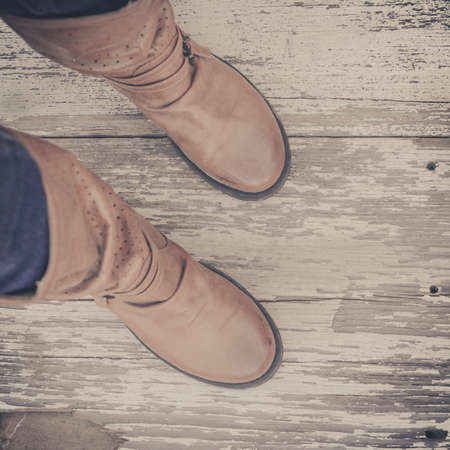 Feet. First-Person view  on rustic wood Floor background.
